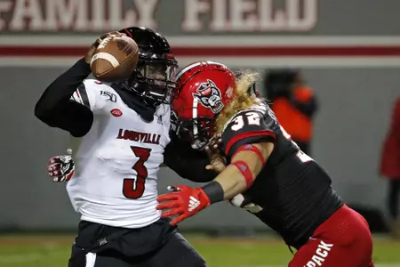North Carolina State's Drake Thomas (32) sacks Louisville quarterback Micale Cunningham (3) during the first half of an NCAA college football game in Raleigh, N.C., Saturday, Nov. 16, 2019. (AP Photo/Karl B DeBlaker)