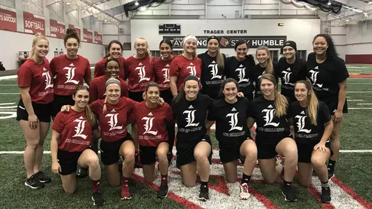 The softball team poses for a photo on day three of the OKC Challenge
