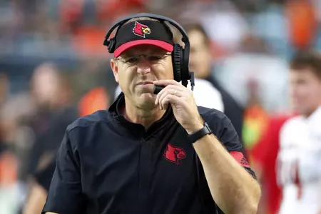 Louisville head coach Scott Satterfield grimaces as he walks the sideline during the first half of an NCAA college football game against Miami, Saturday, Nov. 9, 2019, in Miami Gardens, Fla. (AP Photo/Wilfredo Lee)