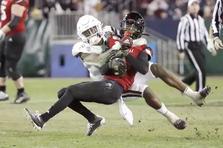 Mississippi State safety Marcus Murphy, left, brings down Louisville wide receiver Chatarius Atwell in the second half of the Music City Bowl NCAA college football game Monday, Dec. 30, 2019, in Nashville, Tenn. (AP Photo/Mark Humphrey)