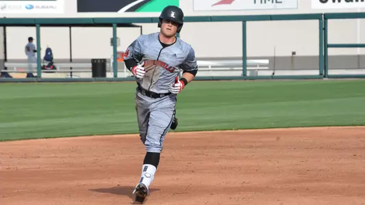 Lucas Dunn rounds the bases after hitting a home run against Connecticut.