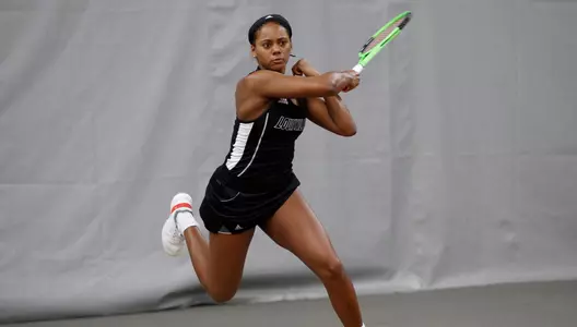 Raven Neely returns a ball against Cincinnati while playing singles.