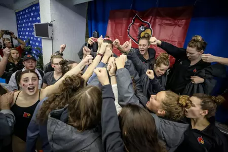 Women's swimming huddles for a cheer before prelims at the ACC Championship