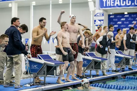 The 800 free relay team celebrates its gold medal win.