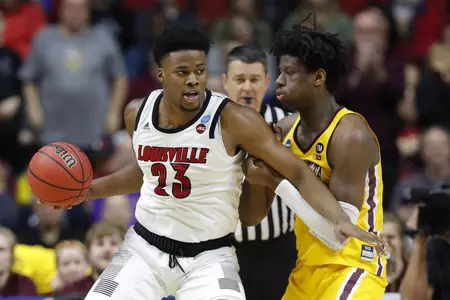 Louisville center Steven Enoch (23) drives around Minnesota center Daniel Oturu, right, during a first round men's college basketball game in the NCAA Tournament, Thursday, March 21, 2019, in Des Moines, Iowa. (AP Photo/Charlie Neibergall)