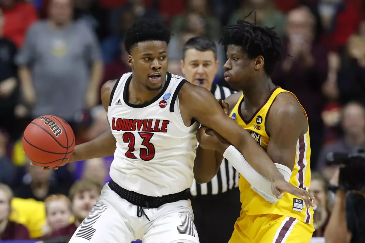 Louisville center Steven Enoch (23) drives around Minnesota center Daniel Oturu, right, during a first round men's college basketball game in the NCAA Tournament, Thursday, March 21, 2019, in Des Moines, Iowa. (AP Photo/Charlie Neibergall)