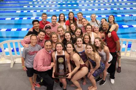 The Cardinals hold their fourth place team trophy at NCAAs.