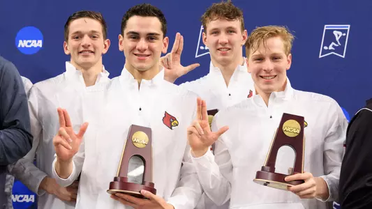 The 800 free relay stands on the podium at the NCAA Championships.