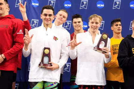The 400 medley relay team stands on the podium at the NCAA Championships.