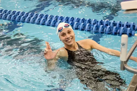 Mallory Comerford throws up her L after the win