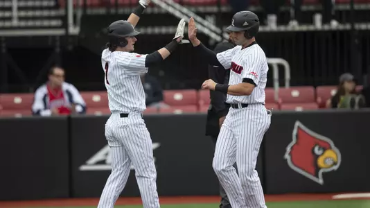 Logan Wyatt and Tyler Fitzgerald high five against Alabama A&M at Jim Patterson Stadium.