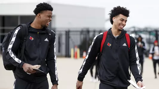 Steven Enoch and Jordan Nwora walking to the airplane