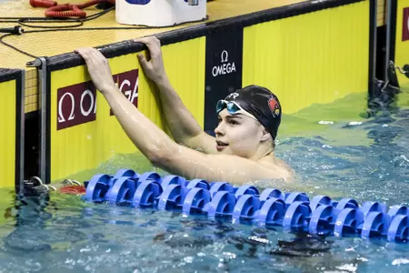 Barna checks his time at the wall.