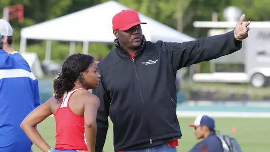 Tony Miller directs a former athlete during a track meet