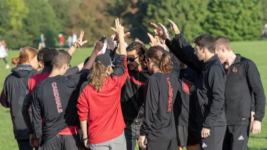 Coach Joe Walker, III give last minute instructions to the men before running in the Louisville Classic