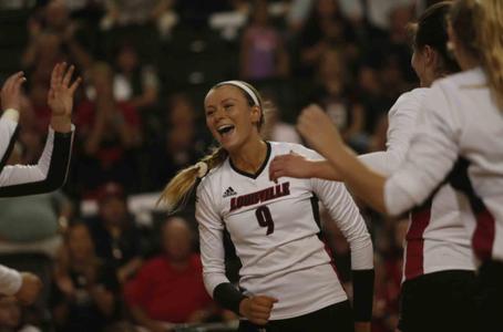 Claire Chaussee celebrates at the net against NC State