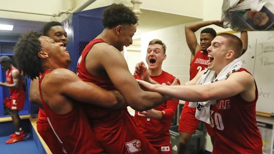 Cardinal team members celebrate in the locker room following their win over Duke on Jan. 18.