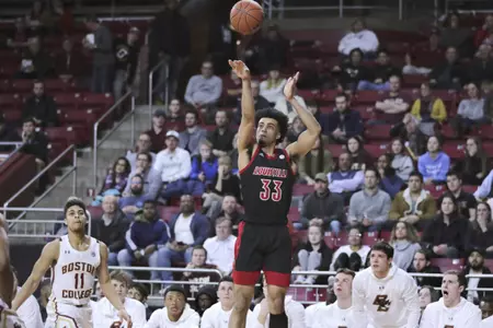 Louisville forward Jordan Nwora (33) shoots as Boston College players watch during the first half of an NCAA college basketball game in Boston, Wednesday, Jan. 29, 2020. (AP Photo/Charles Krupa)