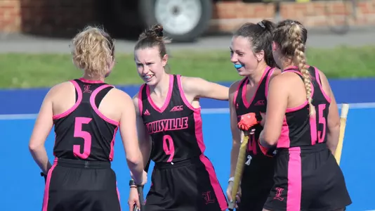 the field hockey team celebrates after a goal against Virginia