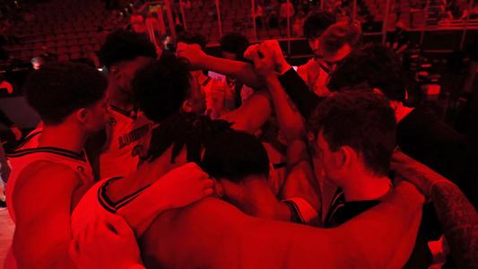 Louisville men's basketball team huddle after starting lineup introductions at UofL's Nov. 27 game vs. Seton Hall 