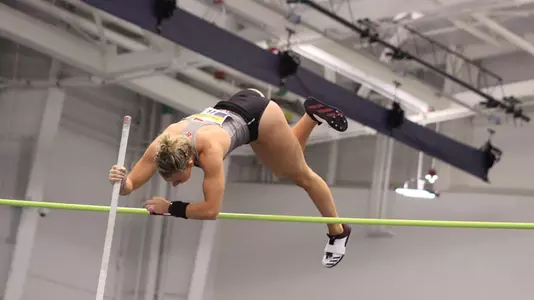 Aliyah Welter competes in the pole vault at an indoor meet