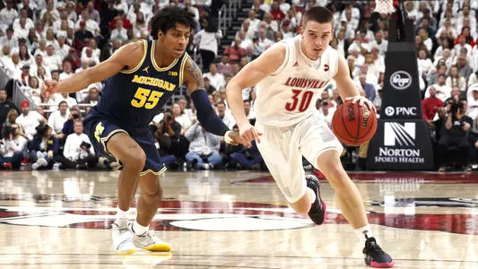 Ryan McMahon drives against No. 4 Michigan in the Cardinals' 58-43 victory.