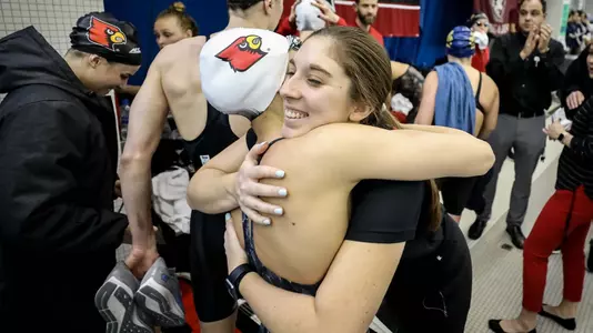 Abigail Solis Hugs UofL swimmer in celebration