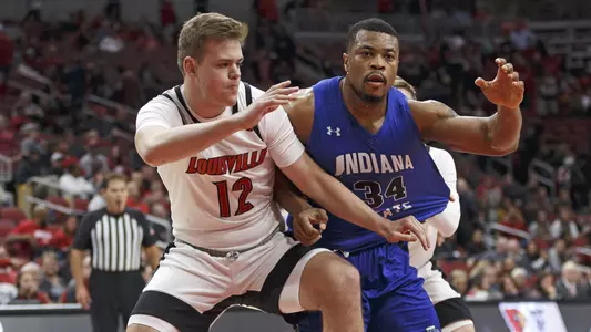 Hogan Orbaugh blocks out an Indiana State player during action in the KFC Yum! Center.