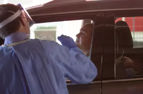 Arthur Albiero waits for his COVID swab in the drive-through testing facility