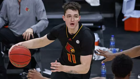 Quinn Slazinski looks for an opportunity to drive against Florida State in the KFC Yum! Center on Jan. 18.