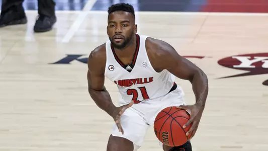 Charles Minlend looks to pass against Duke in the KFC Yum! Center on Jan. 23
