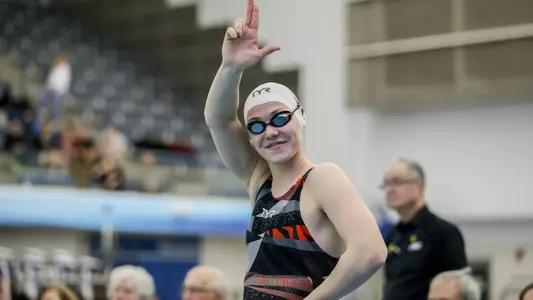 Arina Openysheva waves to the crowd from the blocks