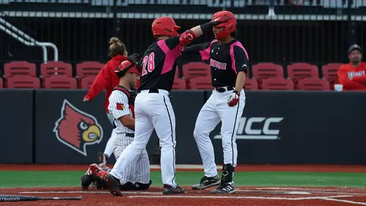 JT Benson and Austin Bode hug after a home run in the Pizza Bowl.