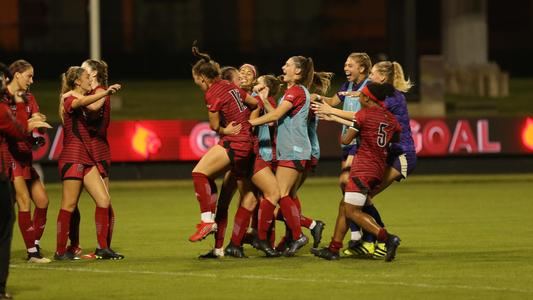 Louisville Women's Soccer rushes the field after Emma Hiscock GW Goal
