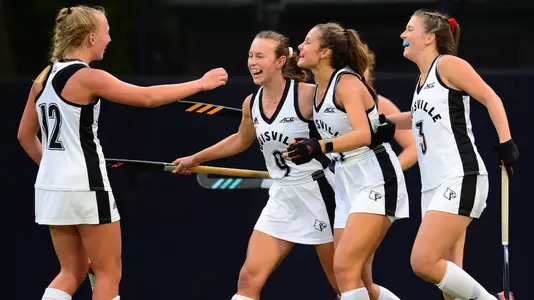 Louisville field hockey players celebrate a goal in the 3-2 overtime win at North Carolina