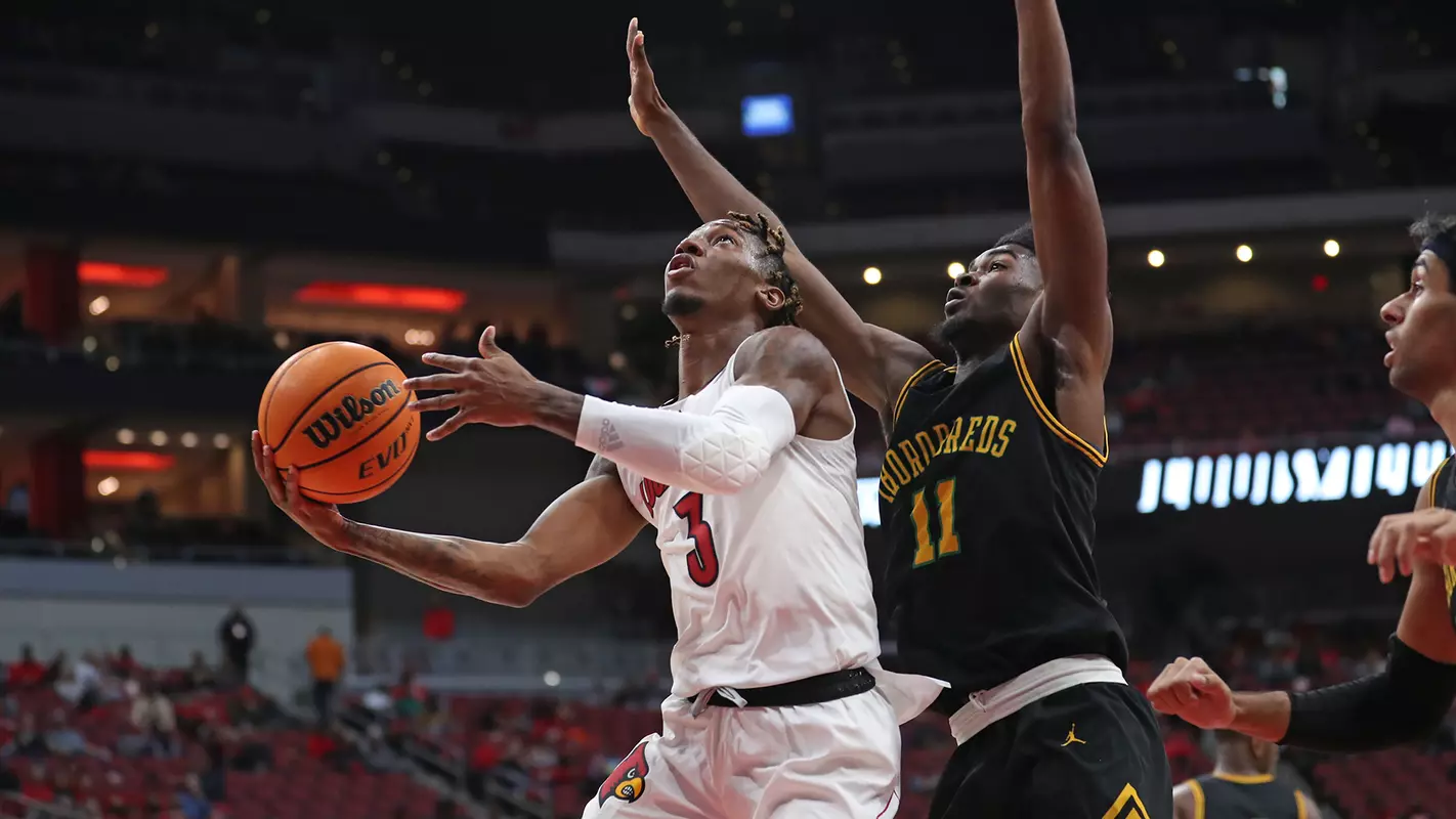 El Ellis drives against Kentucky State in the KFC Yum! Center