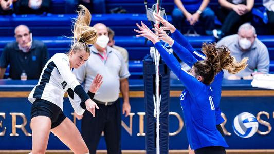 Claire Chaussee swings at the net against Duke 