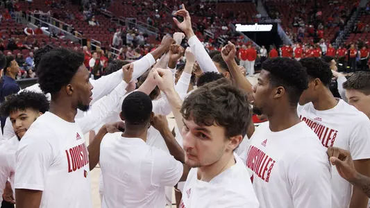 The Cardinals huddle before UofL played Navy in the KFC Yum! Center on Nov. 15, 2021.