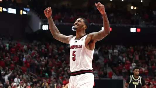 Malik Williams celebrates in the KFC Yum! Center on Dec. 29, 2021.