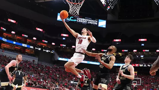Samuell Williamson lays the ball up against Wake Forest in the KFC Yum! Center on Dec. 29, 2021.