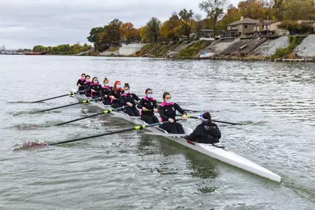 Varsity 8 boat heads down river