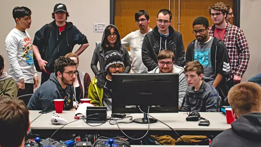UofL eSports group photo, focused on a screen