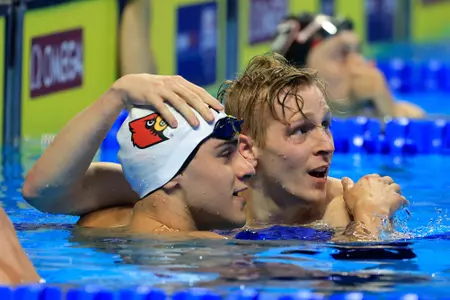 Nick albiero and Zach Harting hug at the blocks
