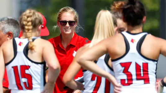 Erin Schneidtmiller address the field hockey team in a huddle