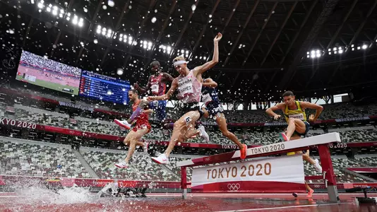 Canada's Matthew Hughes jumps over a barrier in the Tokyo Olympic Steeplechase