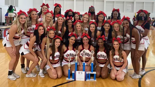 The All-Girl Cheer Squad poses with their trophies
