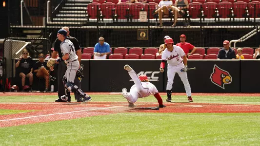 Dalton Rushing dives across the plate against Xavier.
