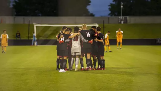 The Cardinals huddle before the Northern Kentucky match.