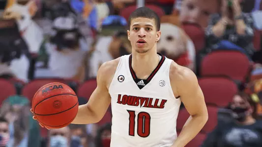 Samuell Williamson brings the ball up the court during a 2021 game in the KFC Yum! Center.