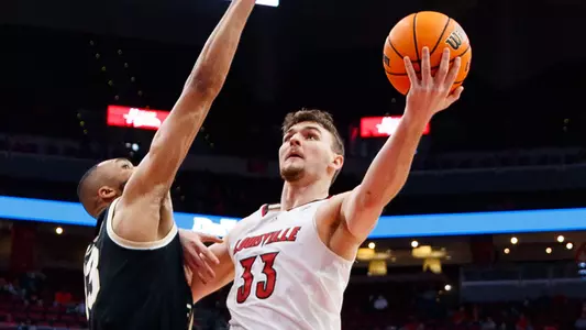 Matt Cross moves to the basket against Wake Forest in the KFC Yum! Center on Dec. 29, 2021.